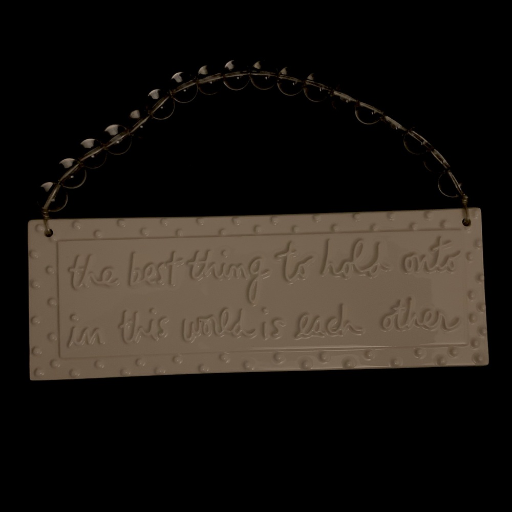 Sandra Magsamen “the best thing to hold onto on this world is each other” sign